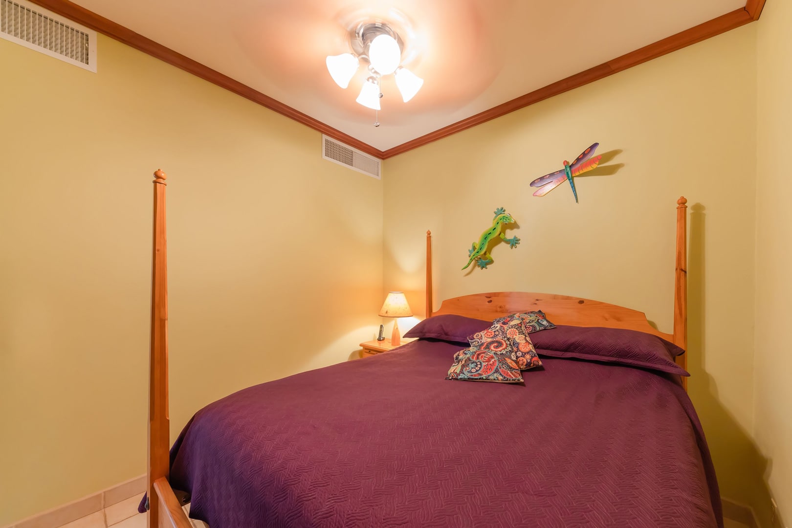 Cozy bedroom with queen bed, perfect for accommodating children or additional guests, adorned with tropical touches.
