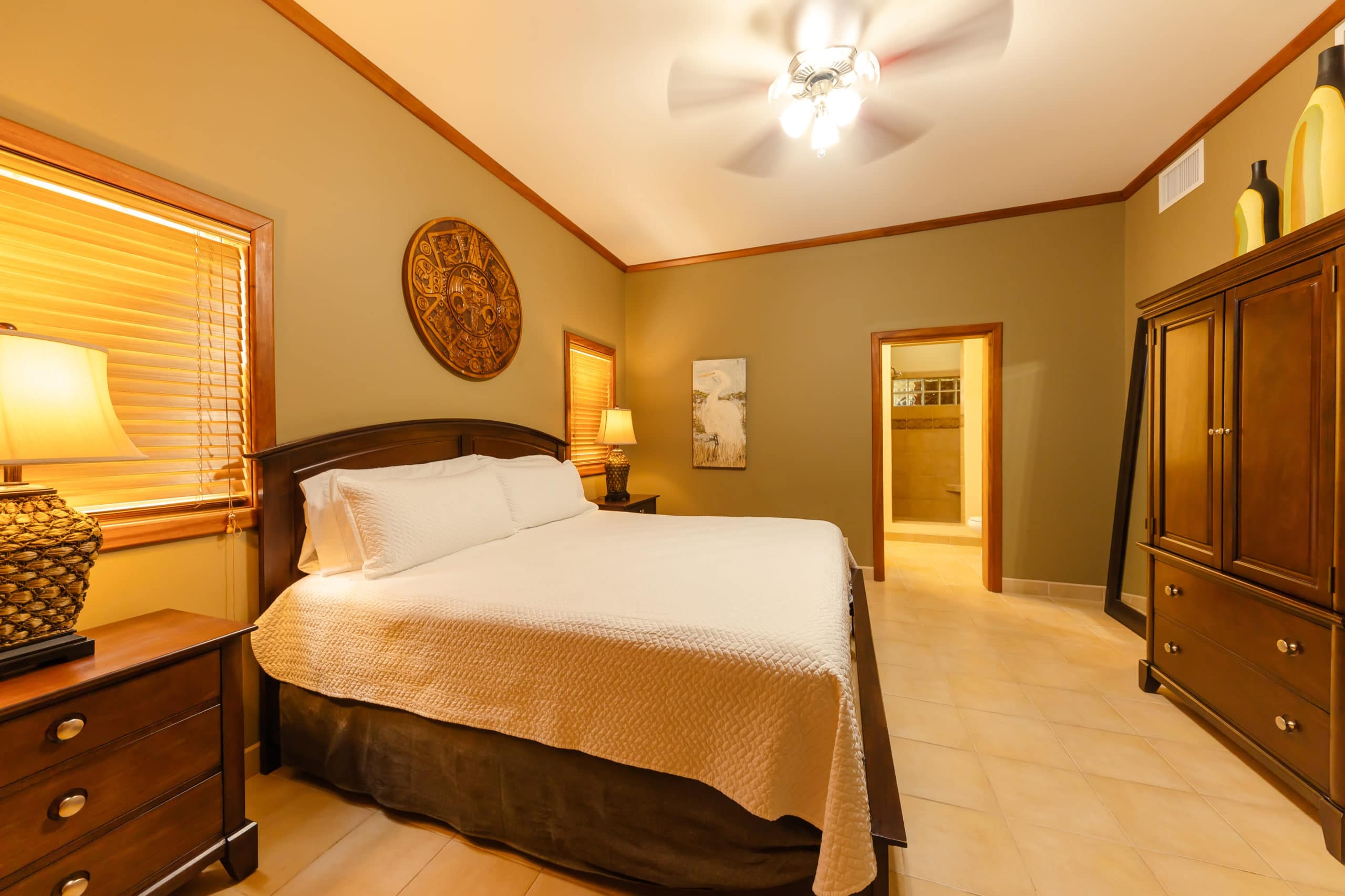 Spacious master bedroom with comfortable king-size bed, elegant decor, and ample natural light.