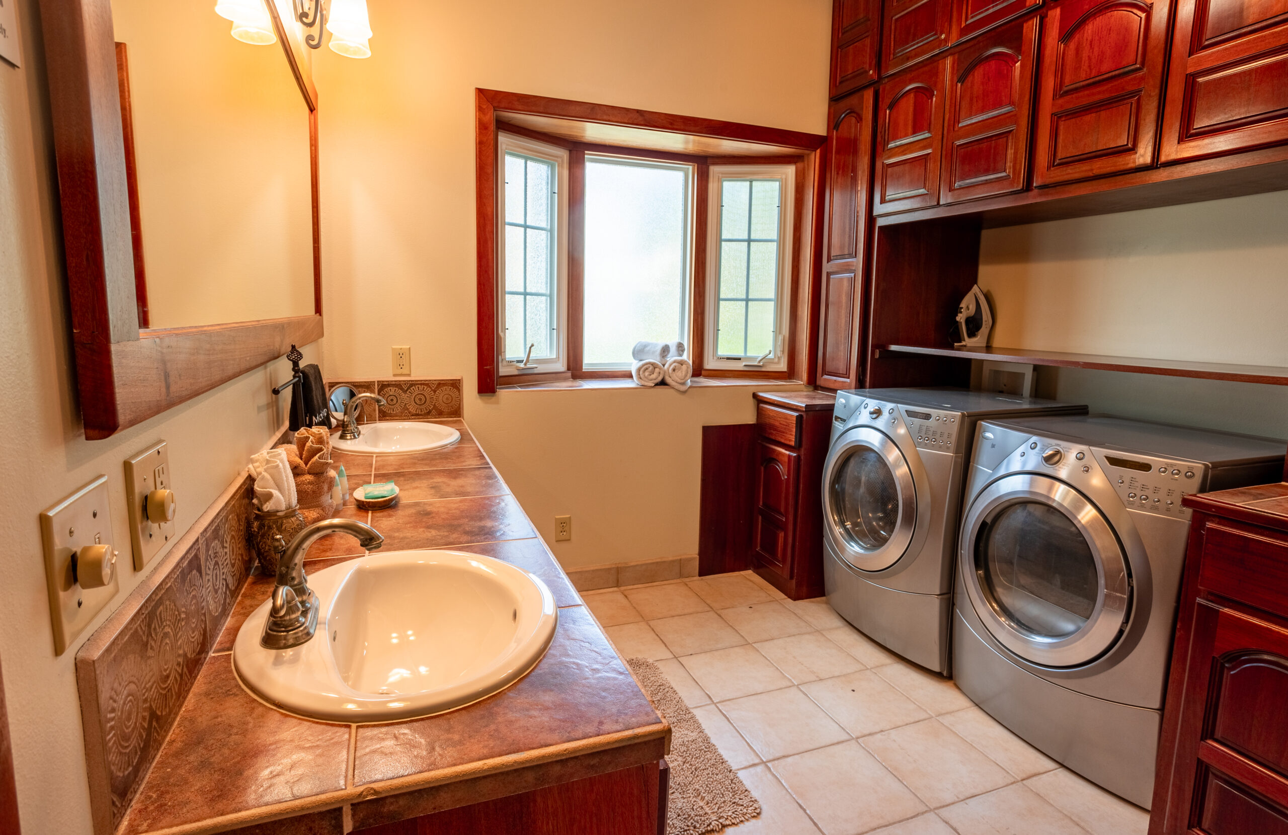 en-suite bathroom with a spacious walk-in shower, a stylish vanity, and all necessary amenities.